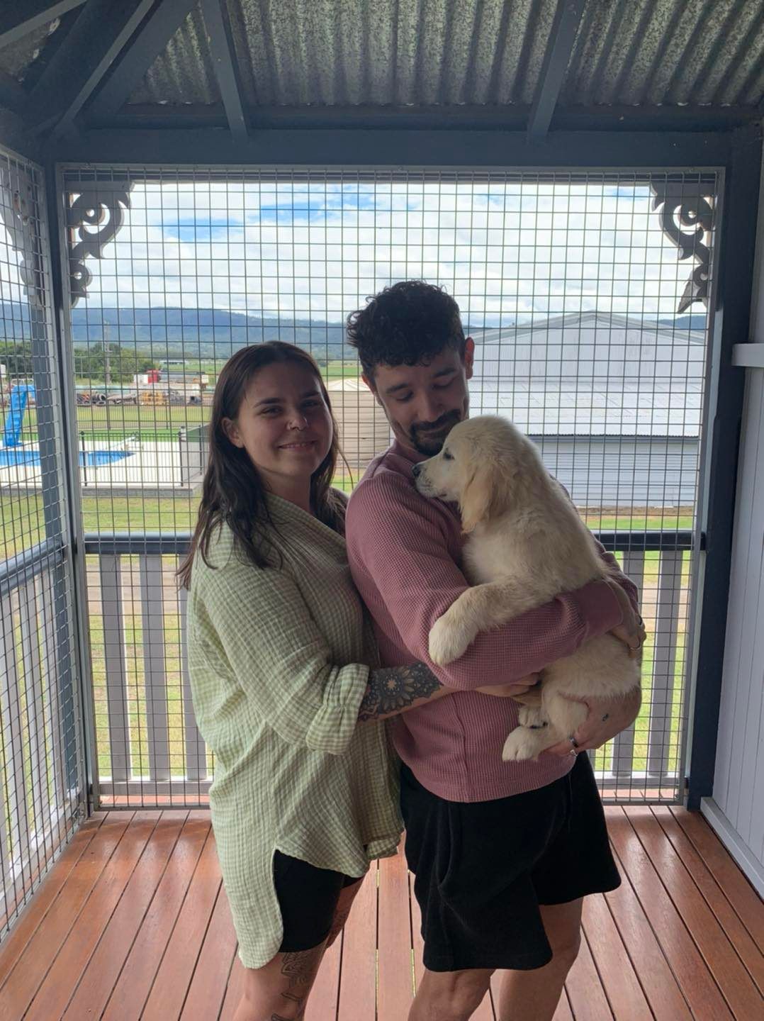 Happy family with their retriever puppy
