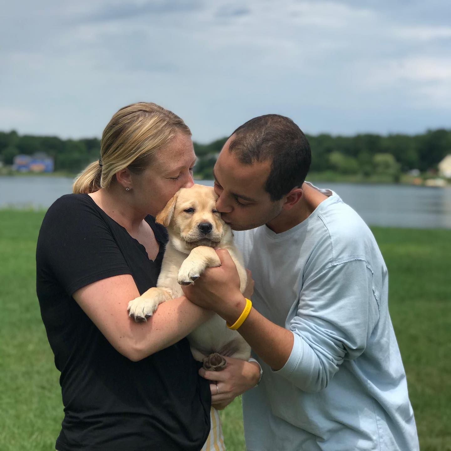 Happy family with their retriever puppy