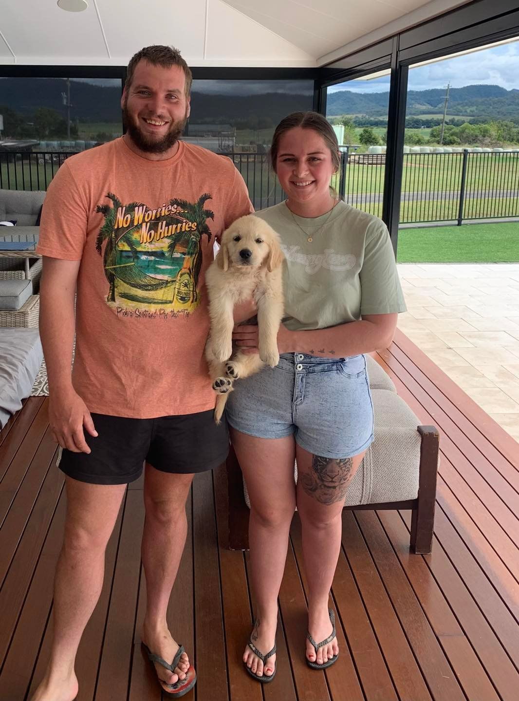 Happy family with their retriever puppy