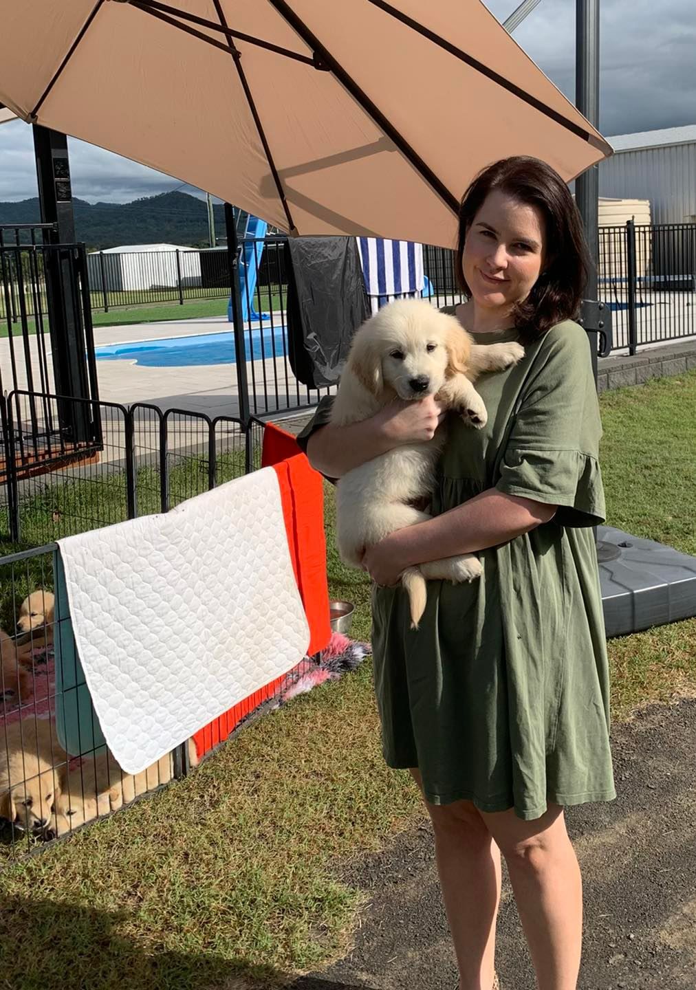 Happy family with their retriever puppy