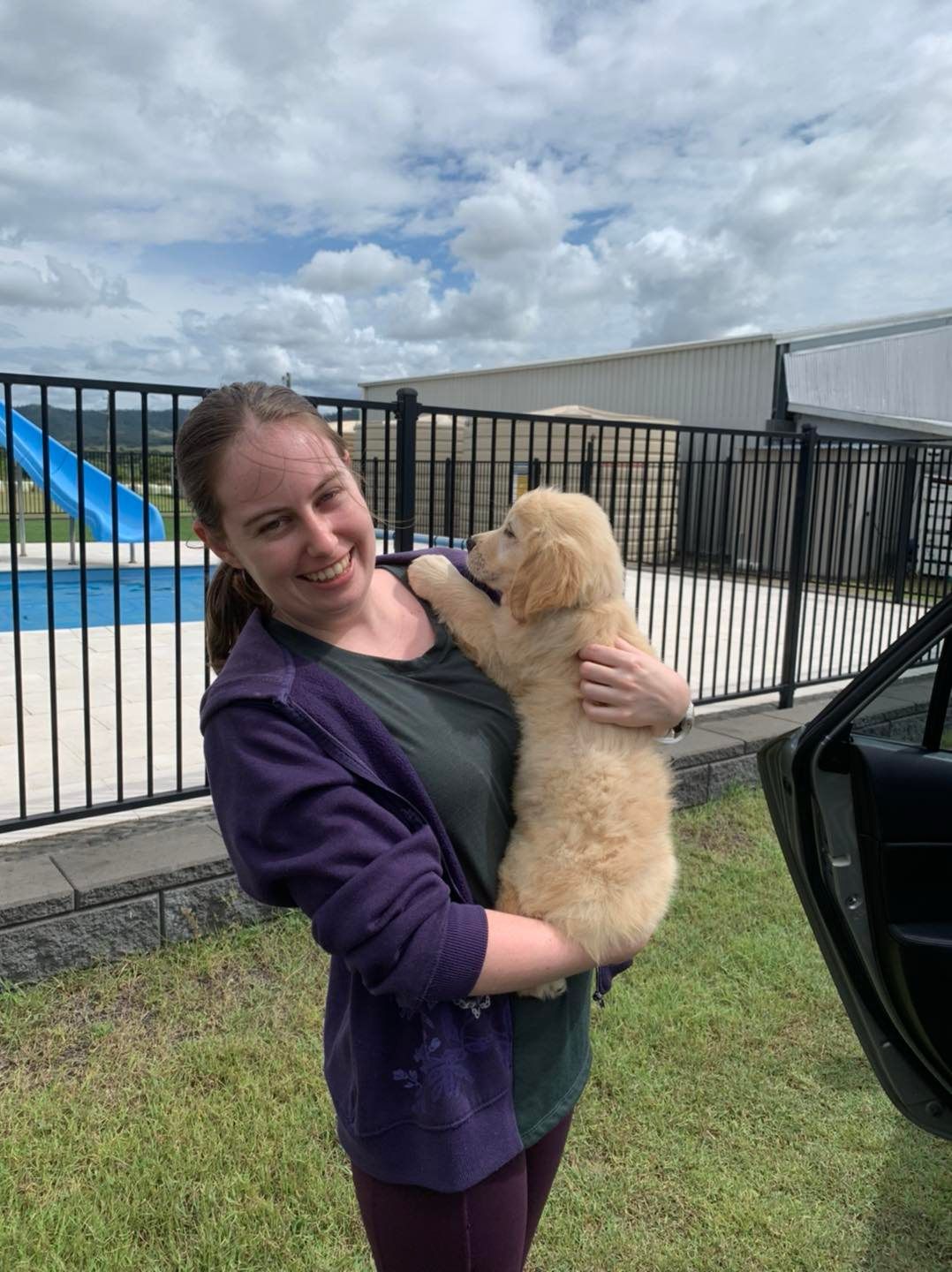 Happy family with their retriever puppy