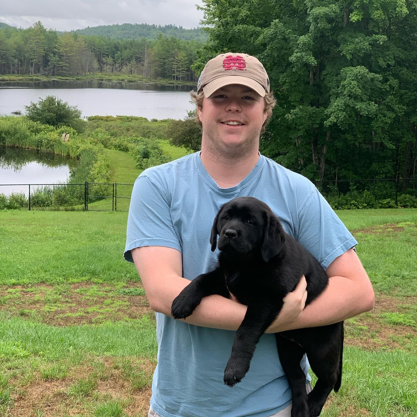Happy family with their retriever puppy