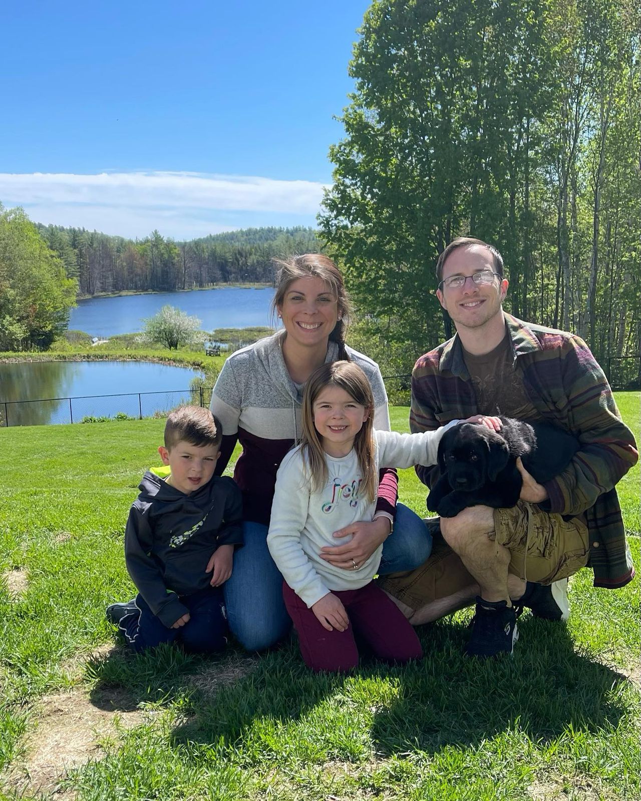 Happy family with their retriever puppy