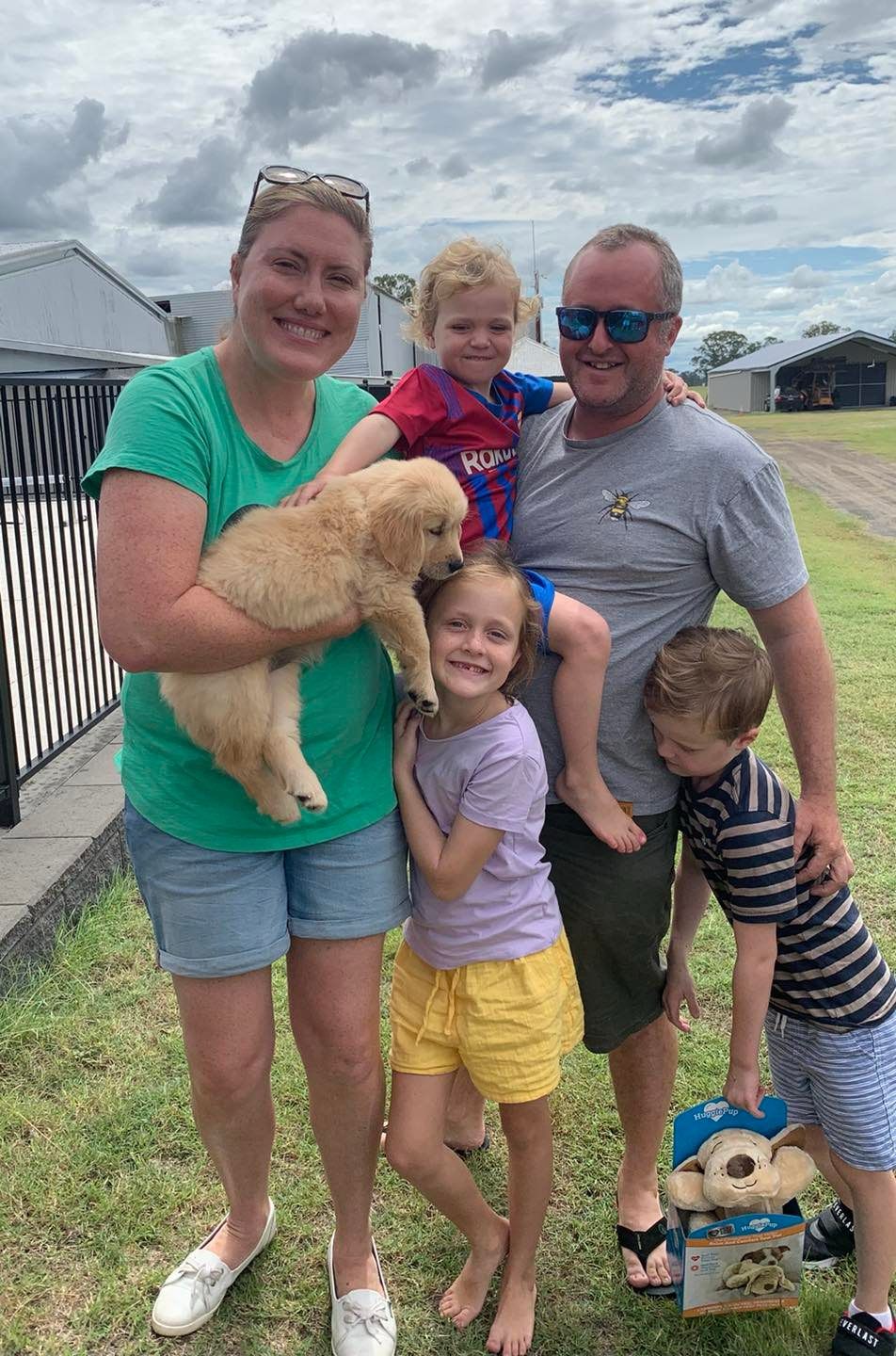 Happy family with their retriever puppy
